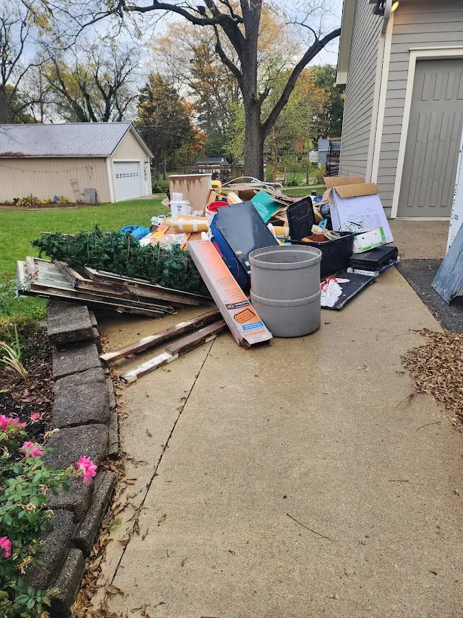 Dumpster being loaded with debris for 12 Yard Dumpster Rental in Great Bend